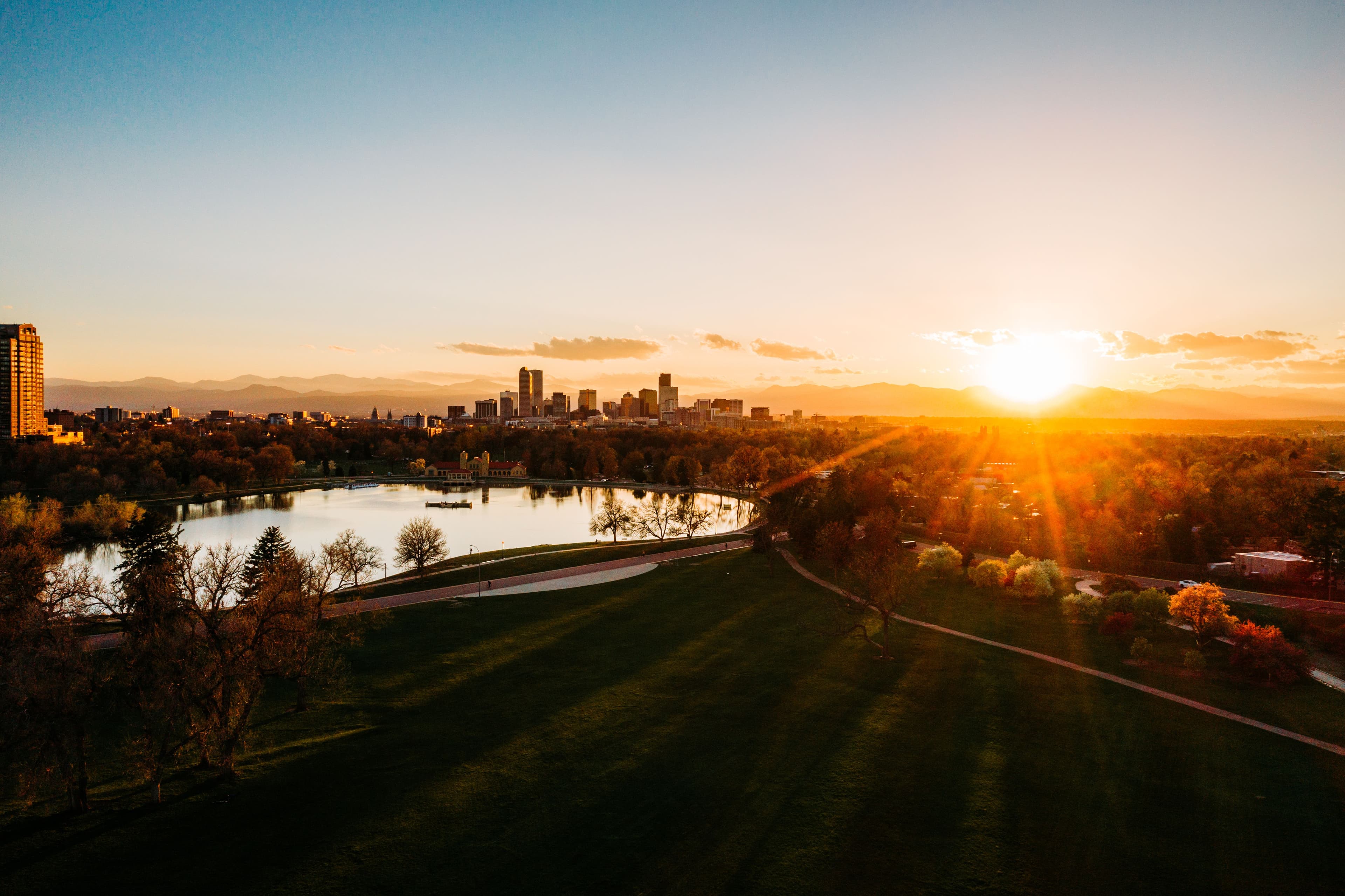 Denver, Colorado skyline at sunset with the Rocky Mountains in the background